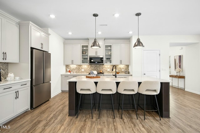 137 Azalea View Way, Holly Springs, NC 27540 - kitchen with stainless steel appliances, backsplash, light wood-style flooring, light countertops, and recessed lighting