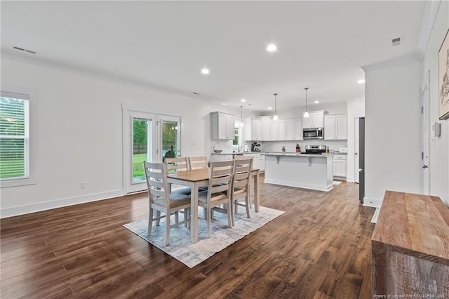 5540 Mountain Run Dr, Hope Mills, NC 28348 - dining space with dark wood-style flooring, crown molding, recessed lighting, and baseboards