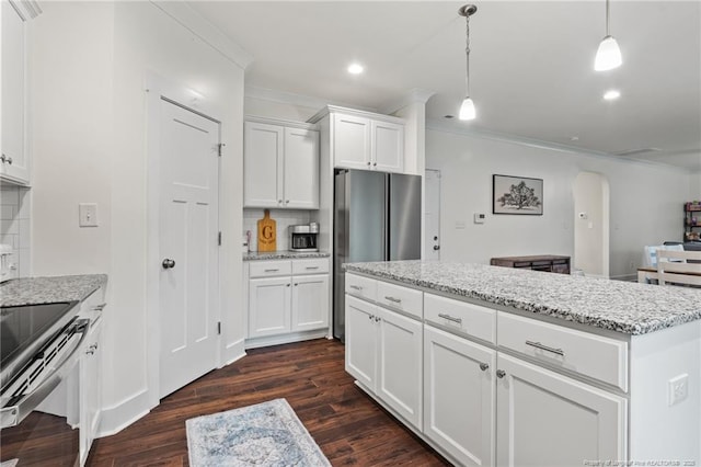 5540 Mountain Run Dr, Hope Mills, NC 28348 - kitchen featuring appliances with stainless steel finishes, crown molding, arched walkways, dark wood finished floors, and tasteful backsplash