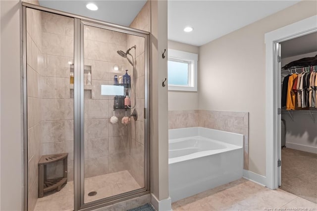5540 Mountain Run Dr, Hope Mills, NC 28348 - full bathroom featuring a garden tub, a stall shower, a walk in closet, tile patterned floors, and recessed lighting