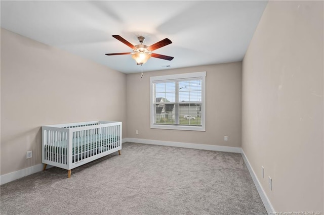 5540 Mountain Run Dr, Hope Mills, NC 28348 - unfurnished bedroom with baseboards, carpet floors, a crib, and a ceiling fan