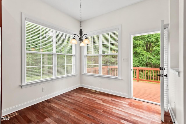 108 Teagan Ct, Chapel Hill, NC 27516 - unfurnished dining area featuring a chandelier, wood finished floors, and plenty of natural light