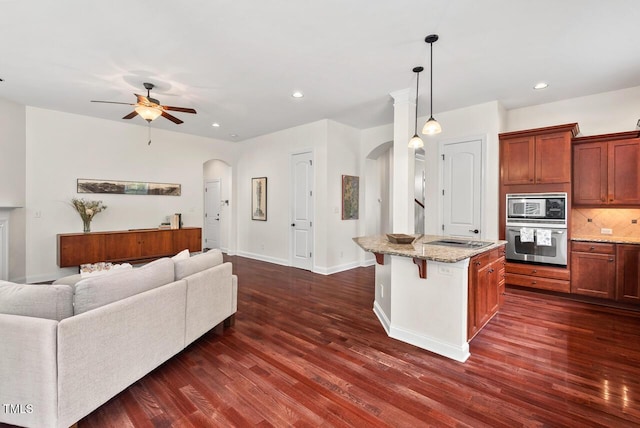 108 Teagan Ct, Chapel Hill, NC 27516 - kitchen featuring appliances with stainless steel finishes, arched walkways, dark wood-style floors, and recessed lighting
