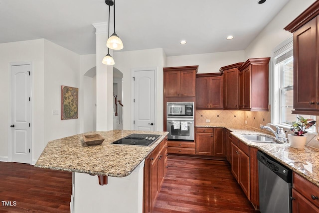 108 Teagan Ct, Chapel Hill, NC 27516 - kitchen featuring stainless steel appliances, dark wood-style flooring, arched walkways, a kitchen island, and recessed lighting