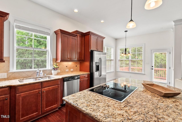 108 Teagan Ct, Chapel Hill, NC 27516 - kitchen featuring appliances with stainless steel finishes, dark wood finished floors, backsplash, decorative light fixtures, and light stone countertops