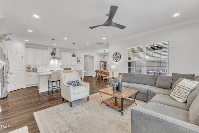 2969 Thirlestane Dr, Apex, NC 27502 - living area featuring dark wood-style floors, a ceiling fan, crown molding, and recessed lighting