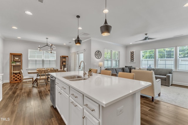 2969 Thirlestane Dr, Apex, NC 27502 - kitchen with stainless steel dishwasher, dark wood finished floors, plenty of natural light, recessed lighting, and ornamental molding