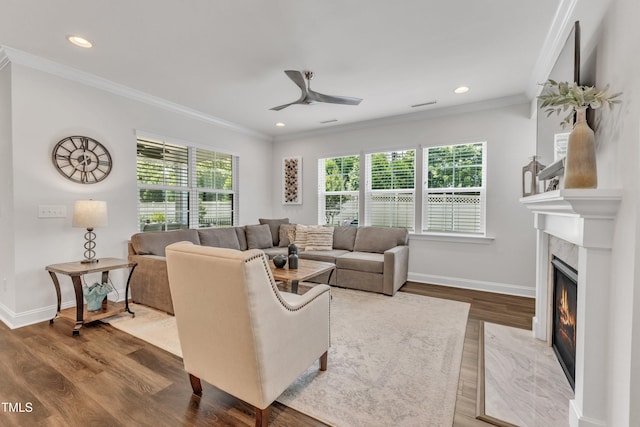 2969 Thirlestane Dr, Apex, NC 27502 - living area featuring a fireplace, wood finished floors, a ceiling fan, ornamental molding, and recessed lighting