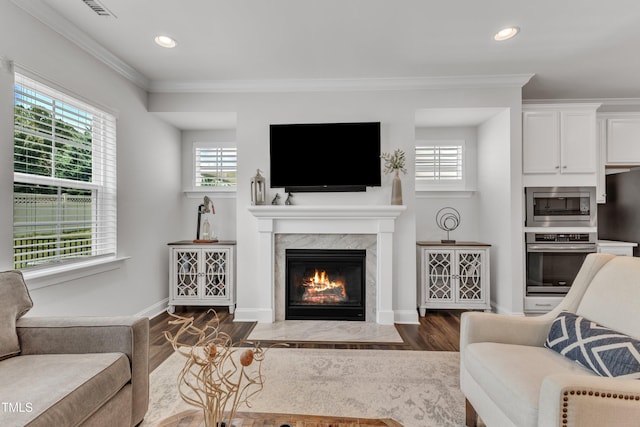 2969 Thirlestane Dr, Apex, NC 27502 - living area with wood finished floors, a fireplace, recessed lighting, and ornamental molding