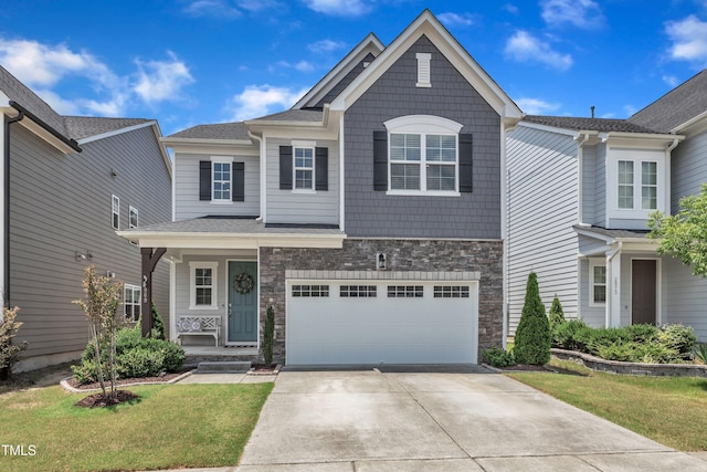 2969 Thirlestane Dr, Apex, NC 27502 - view of front of property with driveway, a garage, stone siding, a front lawn, and covered porch