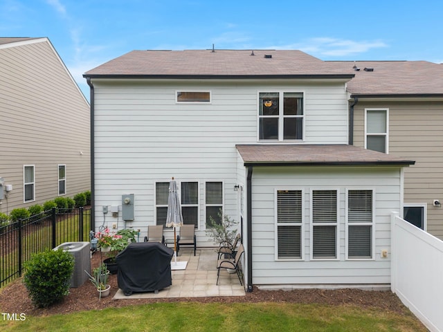 1038 Felman Rd, Durham, NC 27703 - rear view of property with a patio, a fenced backyard, and a shingled roof