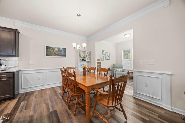 1038 Felman Rd, Durham, NC 27703 - dining space with ornamental molding, dark wood-style floors, and a chandelier