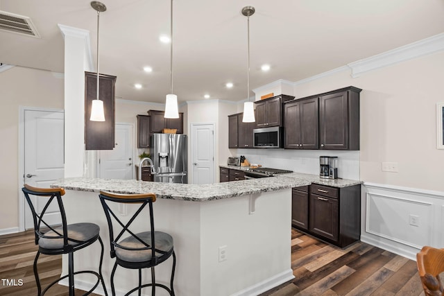 1038 Felman Rd, Durham, NC 27703 - kitchen featuring appliances with stainless steel finishes, crown molding, dark brown cabinets, dark wood-style floors, and a peninsula