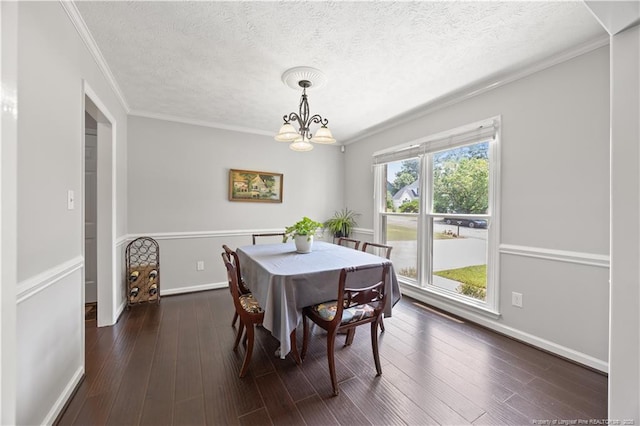 3517 Gables Dr, Fayetteville, NC 28311 - dining room with a chandelier, ornamental molding, dark wood-style flooring, a textured ceiling, and baseboards