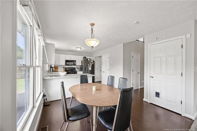 3517 Gables Dr, Fayetteville, NC 28311 - dining area featuring dark wood-style floors, plenty of natural light, and baseboards