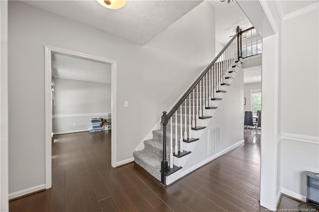 3517 Gables Dr, Fayetteville, NC 28311 - stairs with wood finished floors, baseboards, and a textured ceiling