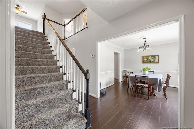 3517 Gables Dr, Fayetteville, NC 28311 - staircase with a chandelier, wood finished floors, baseboards, and ornamental molding