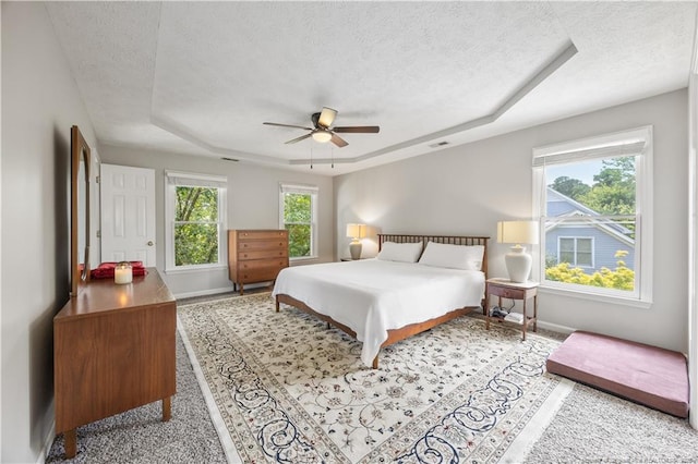 3517 Gables Dr, Fayetteville, NC 28311 - bedroom with a tray ceiling, a textured ceiling, baseboards, and ceiling fan