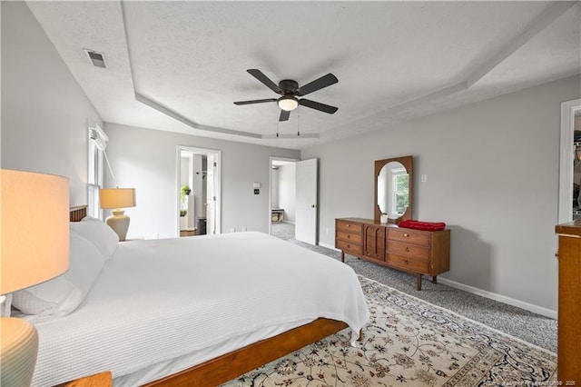 3517 Gables Dr, Fayetteville, NC 28311 - carpeted bedroom featuring baseboards, a raised ceiling, and a ceiling fan