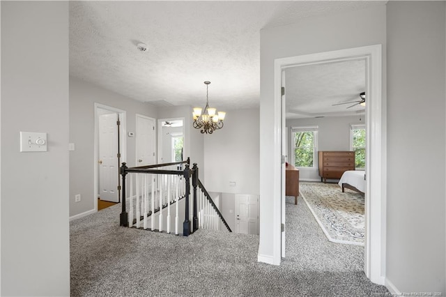 3517 Gables Dr, Fayetteville, NC 28311 - corridor with an upstairs landing, carpet, a textured ceiling, baseboards, and a chandelier