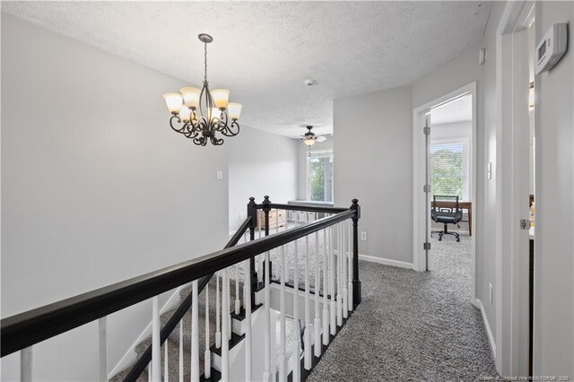 3517 Gables Dr, Fayetteville, NC 28311 - hall with an upstairs landing, a textured ceiling, carpet flooring, a chandelier, and baseboards