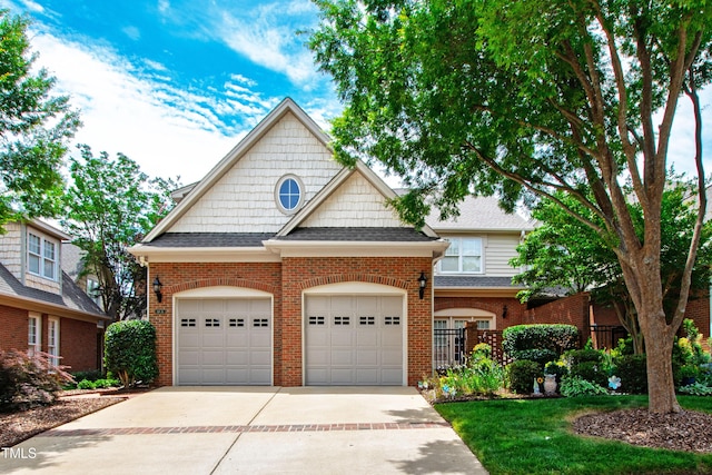 1831 Middlebrook Dr, Raleigh, NC 27615 - view of front facade featuring driveway, a garage, brick siding, and roof with shingles