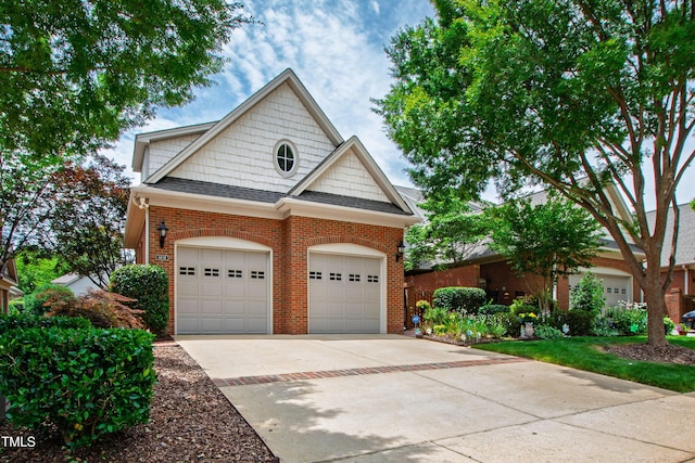 1831 Middlebrook Dr, Raleigh, NC 27615 - view of front of house featuring brick siding, concrete driveway, an attached garage, and a shingled roof