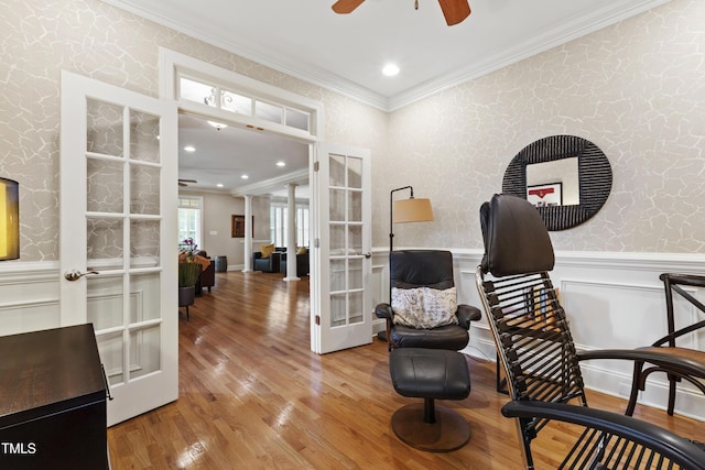1831 Middlebrook Dr, Raleigh, NC 27615 - living area with french doors, a ceiling fan, ornamental molding, wood finished floors, and wainscoting