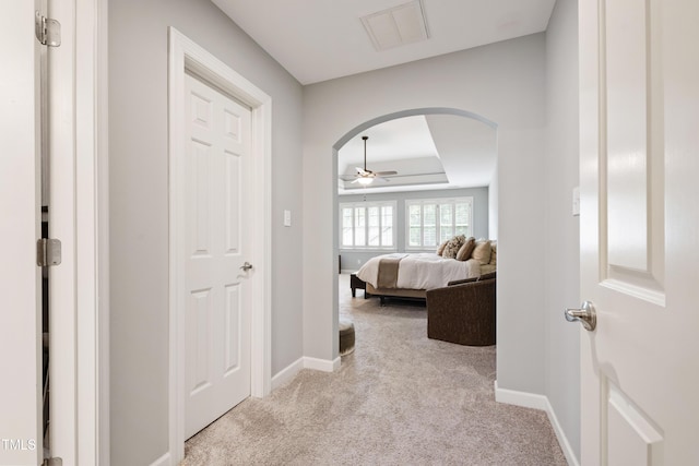 1831 Middlebrook Dr, Raleigh, NC 27615 - hallway featuring arched walkways, light colored carpet, and a tray ceiling