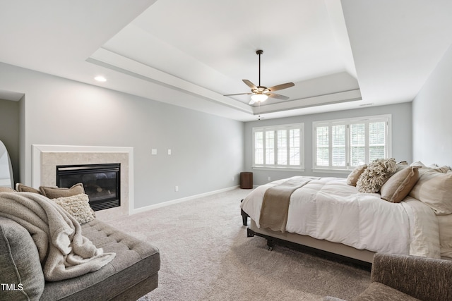 1831 Middlebrook Dr, Raleigh, NC 27615 - carpeted bedroom featuring a tray ceiling, multiple windows, a high end fireplace, and ceiling fan