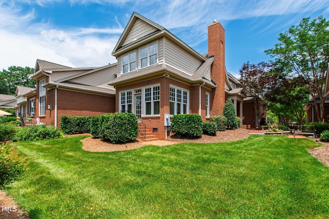 1831 Middlebrook Dr, Raleigh, NC 27615 - back of house with brick siding, a lawn, entry steps, and a chimney