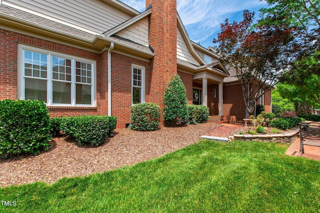 1831 Middlebrook Dr, Raleigh, NC 27615 - view of home's exterior with brick siding, a chimney, and a lawn