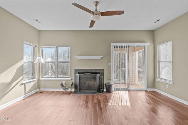 6131 Summerpointe Pl Unit 101, Raleigh, NC 27606 - unfurnished living room with wood finished floors, a fireplace, ceiling fan, and healthy amount of natural light