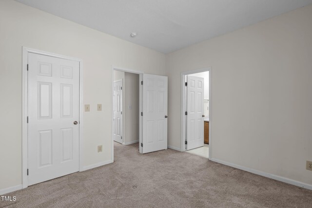 6131 Summerpointe Pl Unit 101, Raleigh, NC 27606 - unfurnished bedroom with light colored carpet and ensuite bathroom