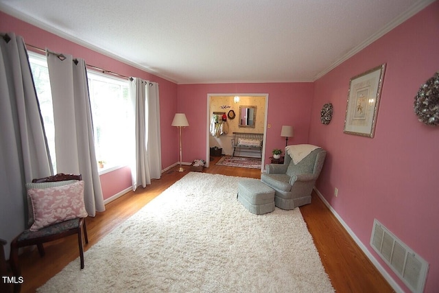 6717 Valley Dr, Raleigh, NC 27612 - living area with wood finished floors and ornamental molding