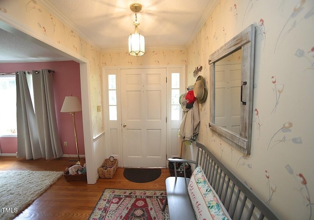 6717 Valley Dr, Raleigh, NC 27612 - foyer entrance with wood finished floors, ornamental molding, and wallpapered walls