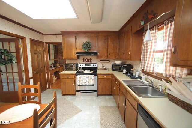 6717 Valley Dr, Raleigh, NC 27612 - kitchen with appliances with stainless steel finishes, under cabinet range hood, brown cabinetry, light countertops, and light floors