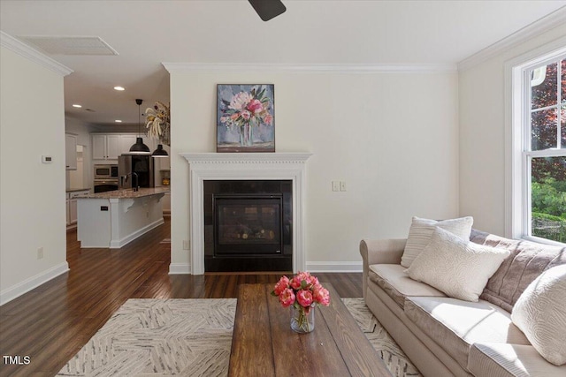 531 Finnbar Dr, Cary, NC 27519 - living room with dark wood-type flooring, crown molding, recessed lighting, a glass covered fireplace, and a ceiling fan