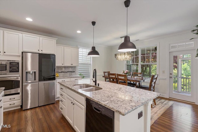 531 Finnbar Dr, Cary, NC 27519 - kitchen with stainless steel appliances, plenty of natural light, dark wood-style floors, ornamental molding, and recessed lighting