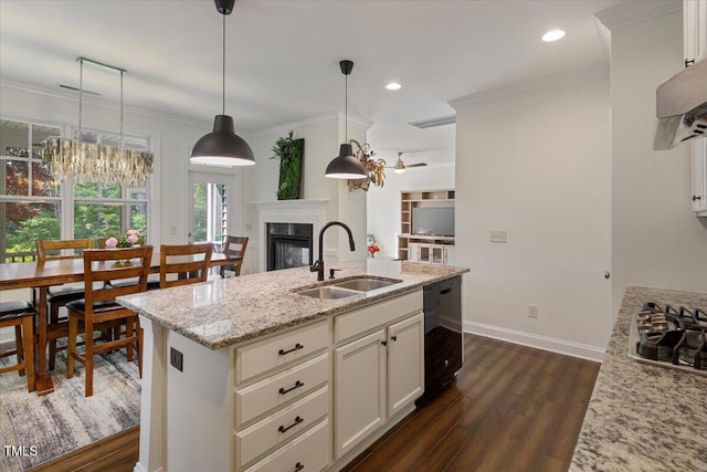 531 Finnbar Dr, Cary, NC 27519 - kitchen featuring black dishwasher, a fireplace, dark wood-type flooring, stainless steel gas cooktop, and light stone counters