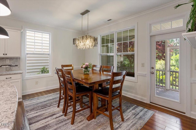 531 Finnbar Dr, Cary, NC 27519 - dining space with a chandelier, dark wood-style floors, and ornamental molding