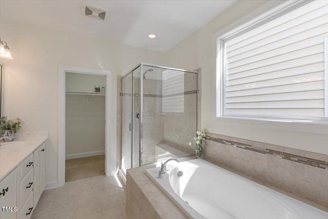 531 Finnbar Dr, Cary, NC 27519 - full bathroom featuring vanity, a shower stall, a garden tub, a walk in closet, and recessed lighting