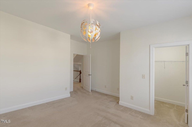 531 Finnbar Dr, Cary, NC 27519 - unfurnished bedroom with a chandelier, a walk in closet, and light colored carpet
