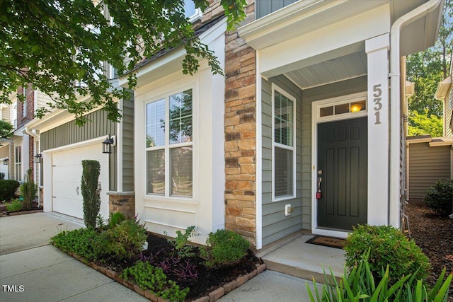 531 Finnbar Dr, Cary, NC 27519 - property entrance with stone siding, driveway, and a garage