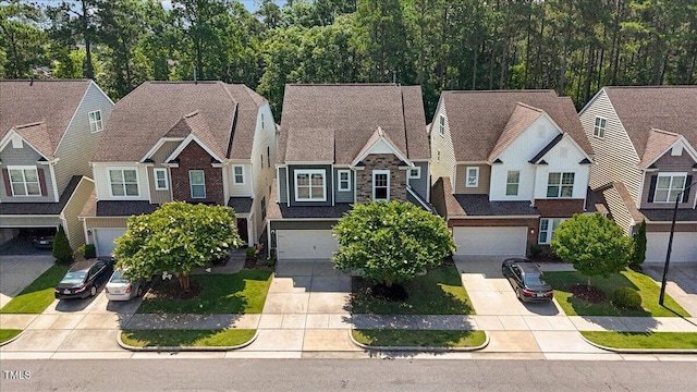 531 Finnbar Dr, Cary, NC 27519 - view of front of house featuring driveway, a garage, a residential view, and stone siding