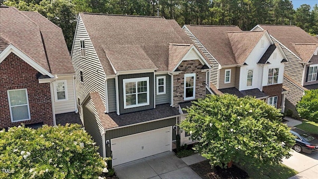 531 Finnbar Dr, Cary, NC 27519 - view of front of house with a garage, driveway, roof with shingles, and stone siding