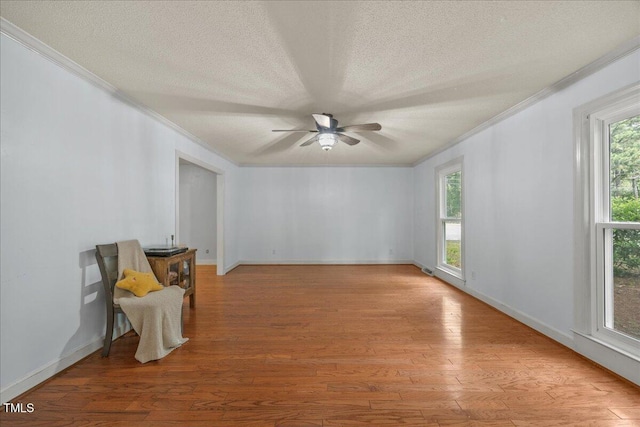 1013 Oak Forest Dr NW, Wilson, NC 27896 - unfurnished room featuring ornamental molding, a ceiling fan, light wood-style flooring, and a textured ceiling