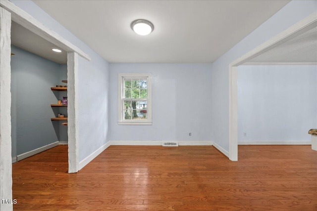 1013 Oak Forest Dr NW, Wilson, NC 27896 - unfurnished room featuring baseboards and wood finished floors
