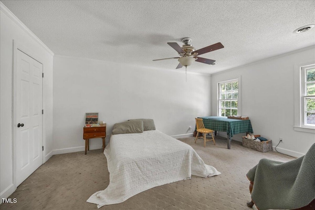 1013 Oak Forest Dr NW, Wilson, NC 27896 - bedroom with ornamental molding, a textured ceiling, ceiling fan, and carpet