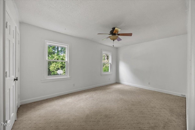 1013 Oak Forest Dr NW, Wilson, NC 27896 - empty room featuring a ceiling fan, carpet, and a textured ceiling